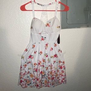 Cute flowery white dress, compliments the summer season and beach!